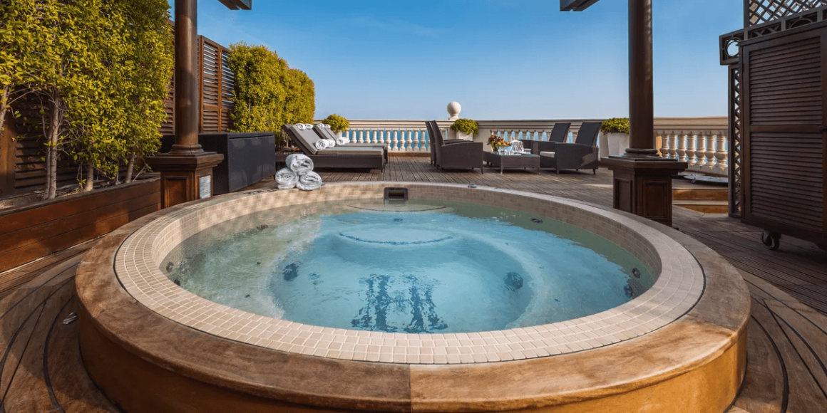 "Seductive outdoor Jacuzzi surrounded by comfortable loungers, with stunning views of Monaco's surrounding countryside."