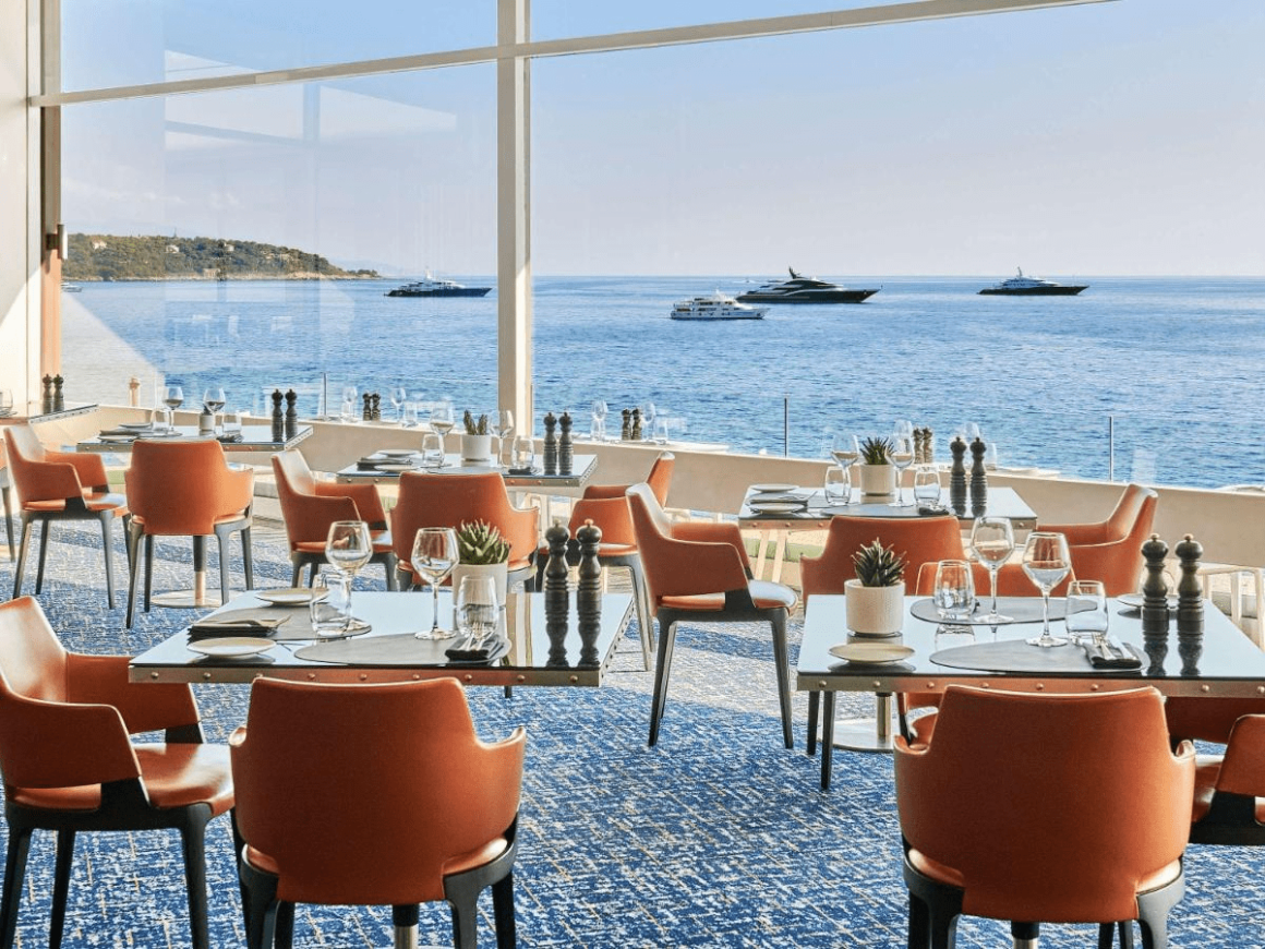 Enchanting view from a restaurant in Monaco, with a panoramic view of the luxury yachts bobbing on the sparkling Mediterranean Sea.