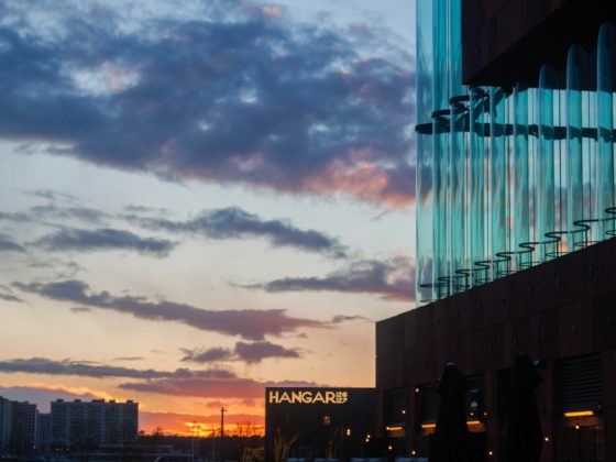 a sunset view of a building with a sign on it